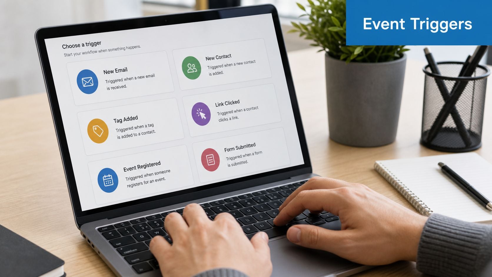 A person typing on a laptop screen displaying various automation event triggers like new contact or email.