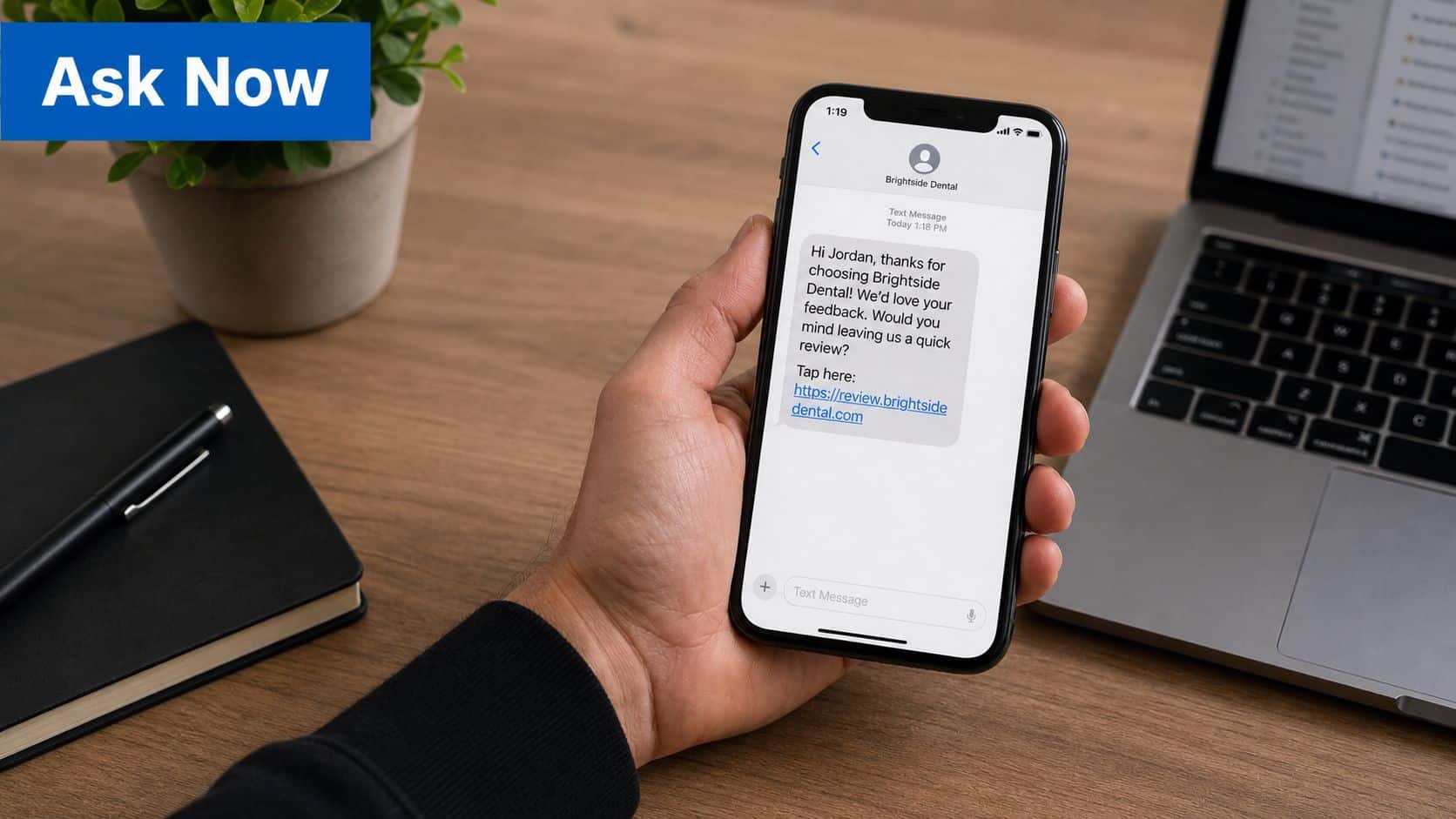 A person holding a smartphone displaying a request for a customer review from a dental office.